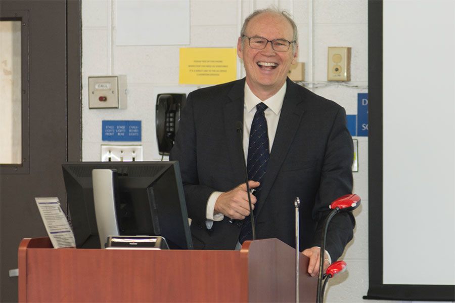 Dr. Joseph C. Kolars smiling from a podium