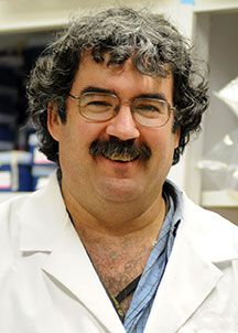 Dr. John Hawdon posing for a portrait in a lab