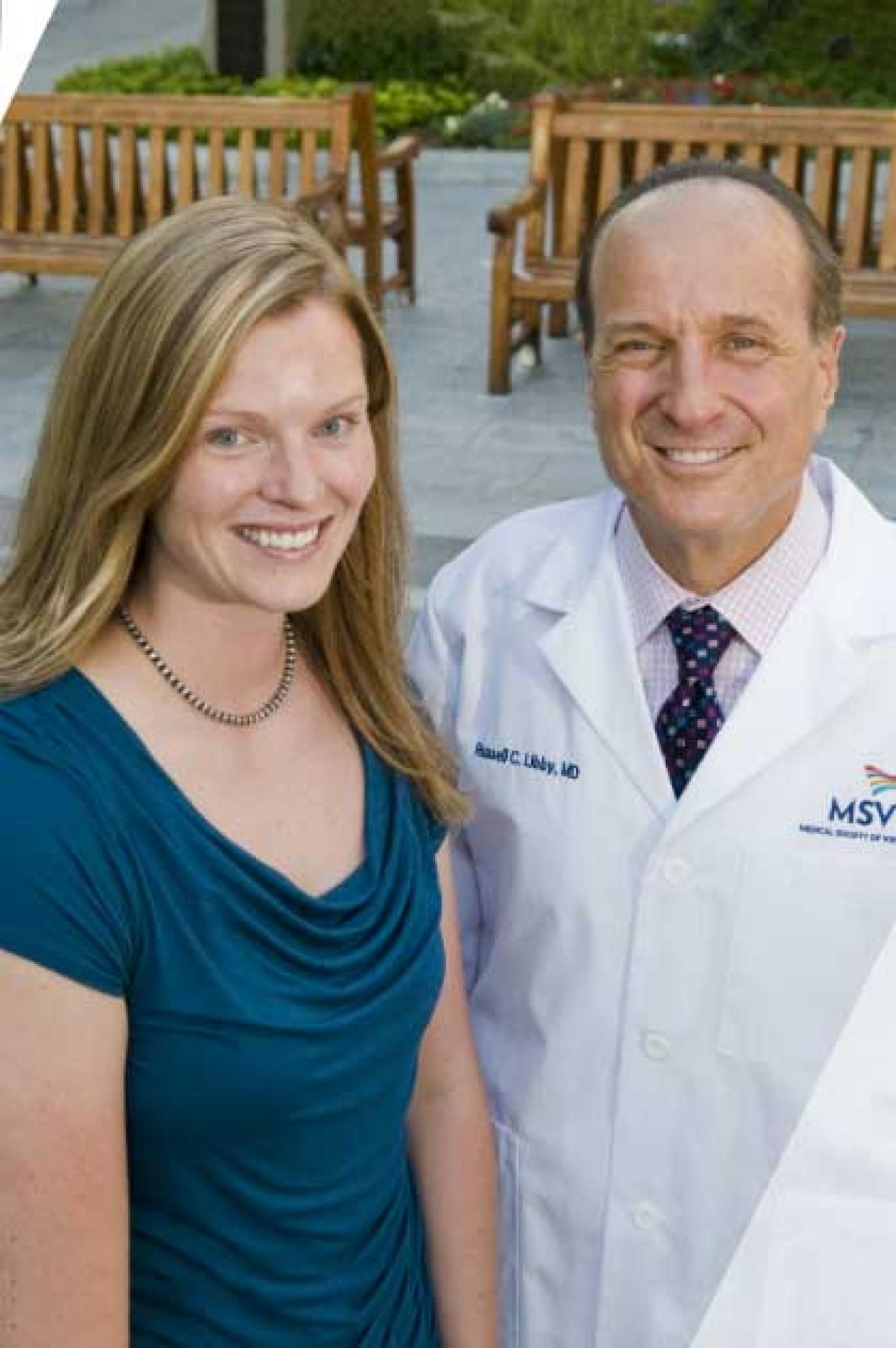 A female medical student is shown with a male alumni doctor.