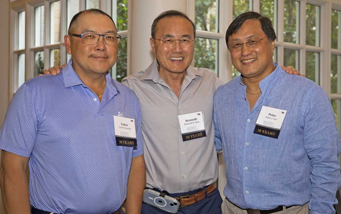 Three members of the MD program Class of 1992 pose for a photo