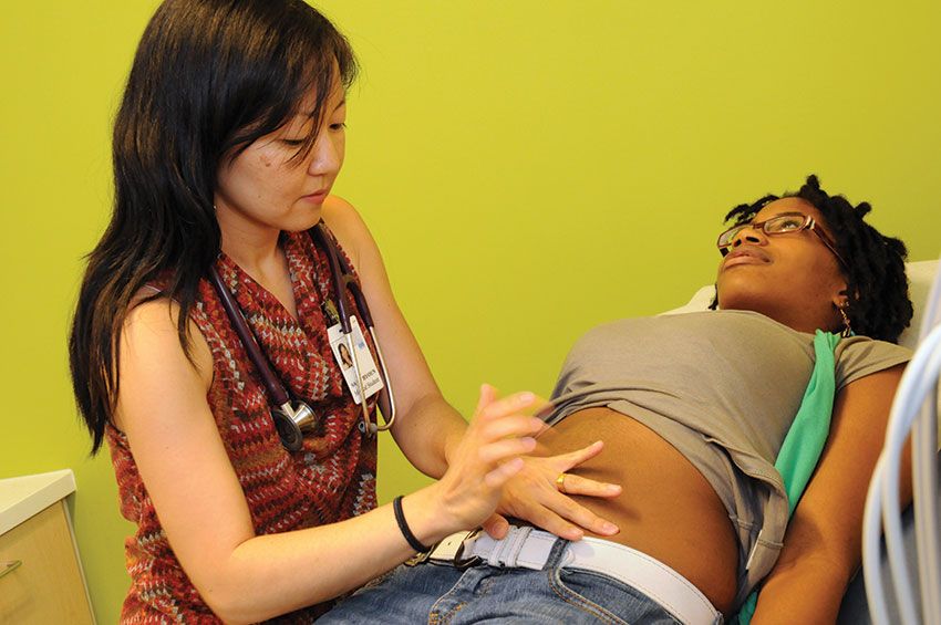 A medical professional examining a patient's stomach