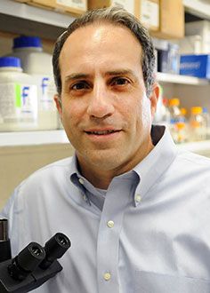 Dr. Jeffrey Bethony posing for a portrait in a lab