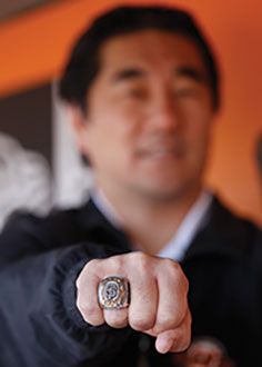 Dr. Ken Akizuki holding out his fist wearing a World Series ring