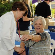 A woman receiving a blood pressure evaluation