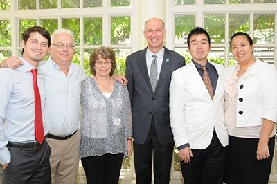 Jiyong Lee and his wife Ji-Min Hong (right) at the SMHS Legacy Brunch with Sandra Caskie, MD'82 (third from left), her husband Julian Safran, MD'75, and son Jeremy Safran, SMHS'17, along with SMHS Dean Jeffrey Akman (center).