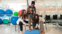 Physical therapists helping a patient