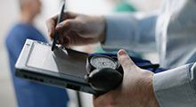 A doctor uses an electronic notepad