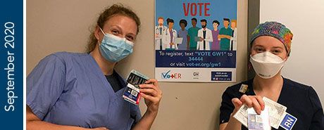Two medical personnel holding voting cards and pamphlets | "September 2020"