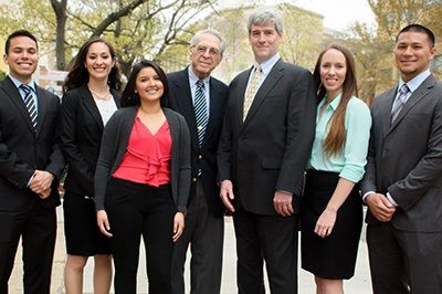 Seven people pose for a photo