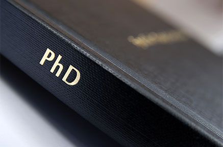 A diploma cover labeled 'PhD'
