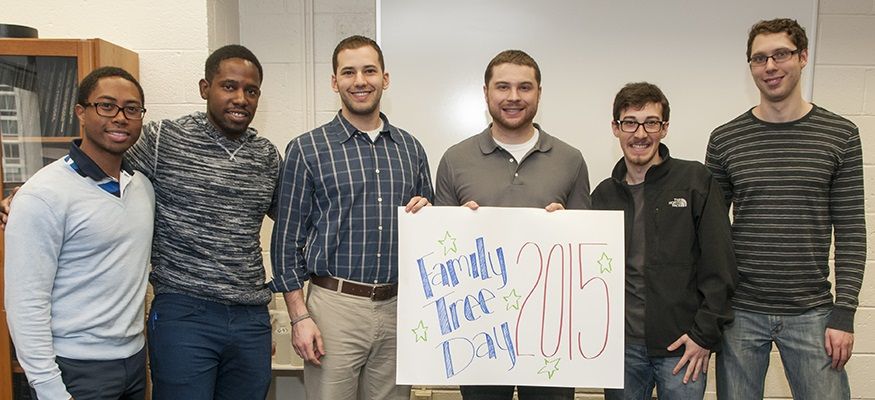 Six medical students hold up a sign that says, 'Family Tree Day 2015'