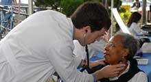 A med student provides a health screening to a woman