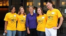 Four women and a man pose for a photo