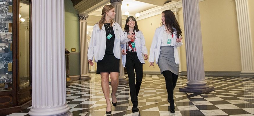 Three first-year medical students walk within the White House during Intersession on &quot;How Physicians Can Create an AIDS-Free Generation.&quot;"