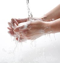 hands with soap under running water