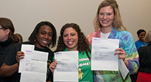 Students holding match day letters and smiling