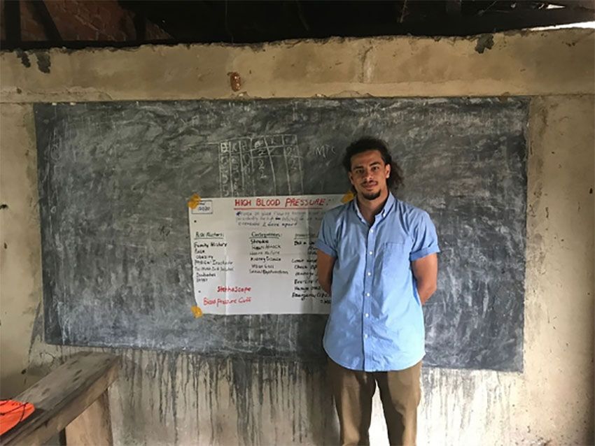 Abdelrhman Elnasseh posing for a picture in front of a chalkboard