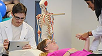 Physical therapy doctors working with a patient