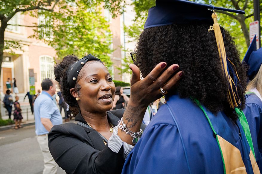 Woman congratulates student