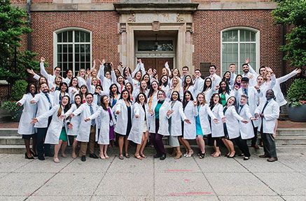 The PA class of 2022 posing together in white coats