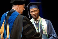 Health sciences graduate getting diploma in cap and gown