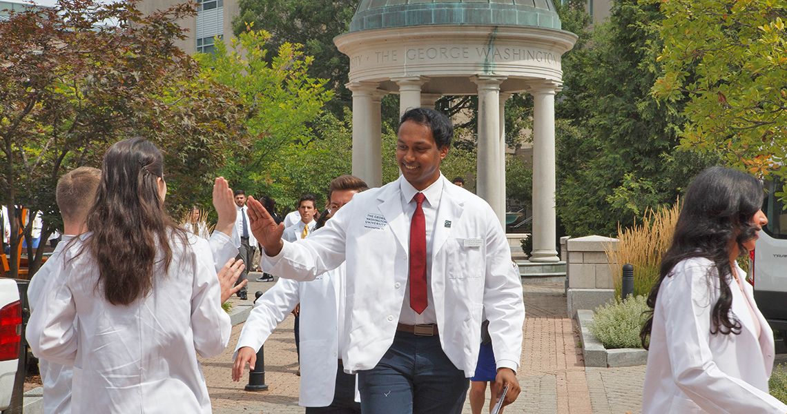 Student in Kogan Plaza after White Coat ceremony