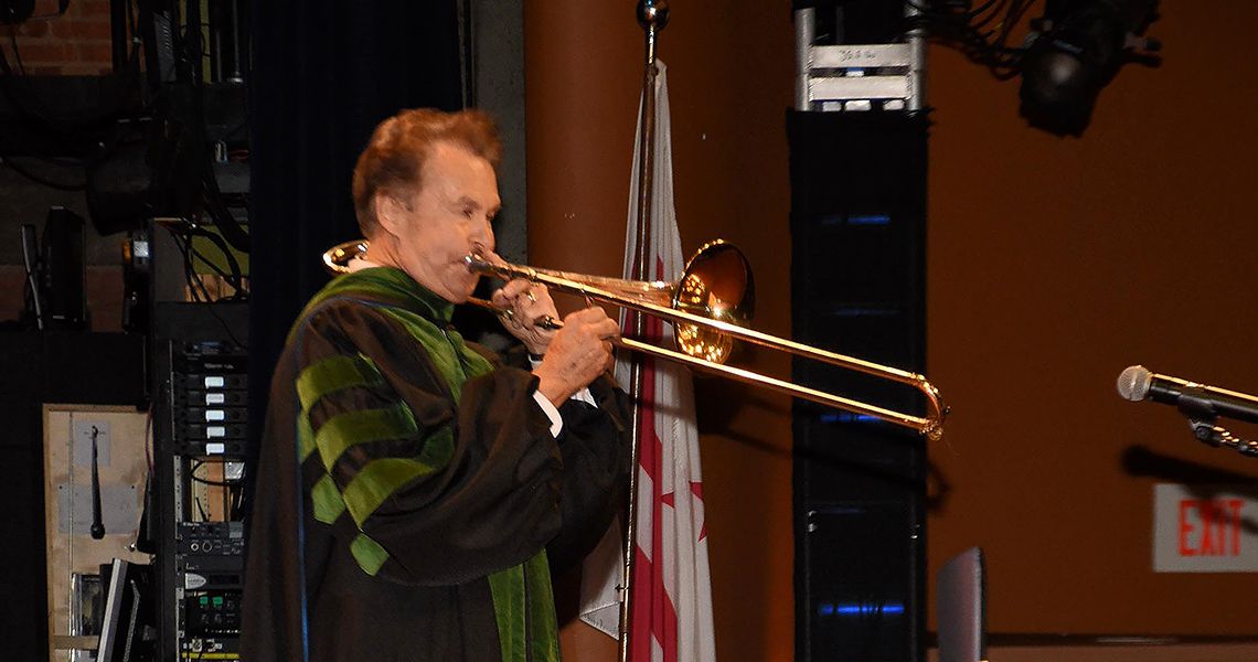 Senior Associate Dean Richard Simons plays trombone at the 2024 MD graduation