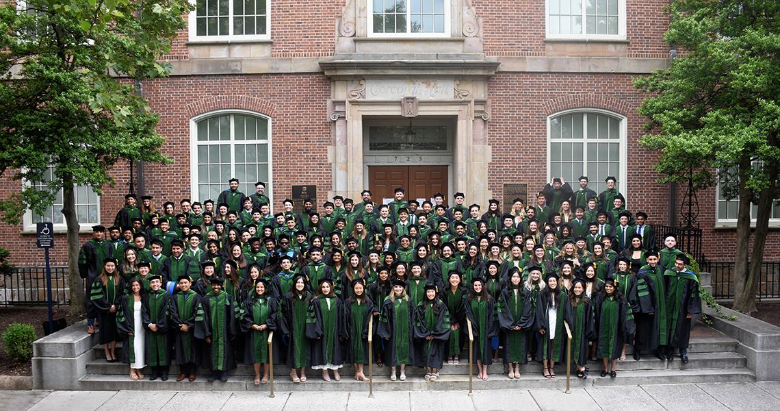 Graduates pose for group photo after ceremony