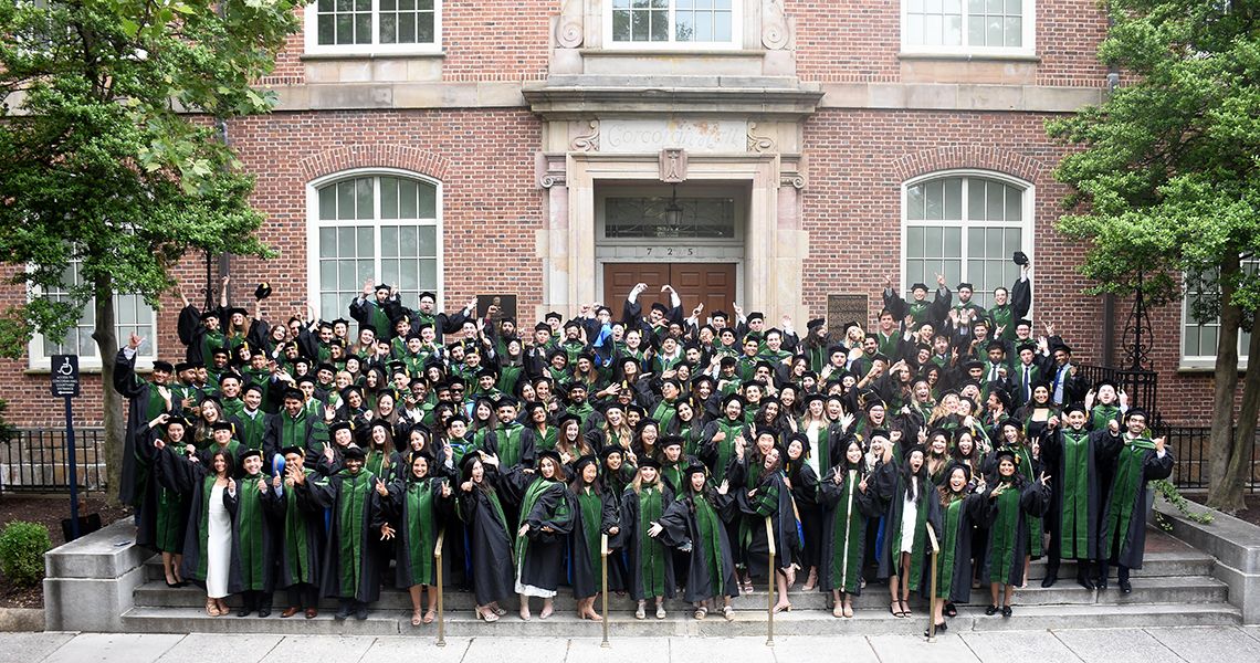 Graduates make faces for playful group photo after ceremony