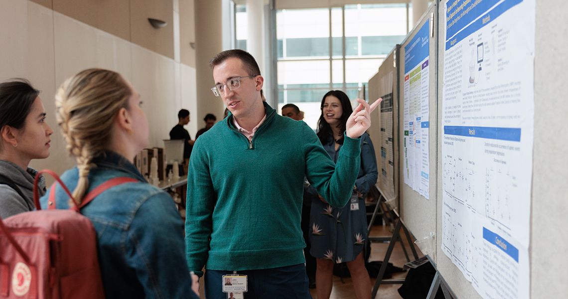 Student discusses his research during poster session