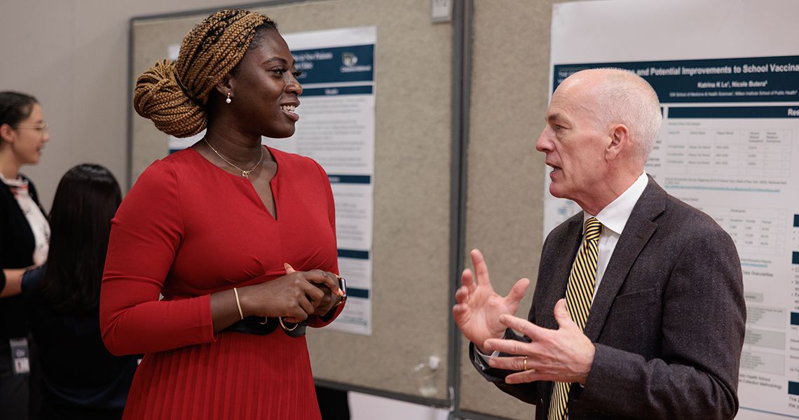 Student discusses her research during poster session