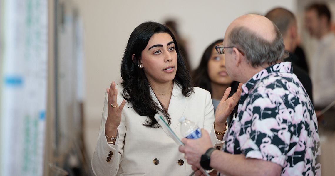 Student discusses her research during poster session