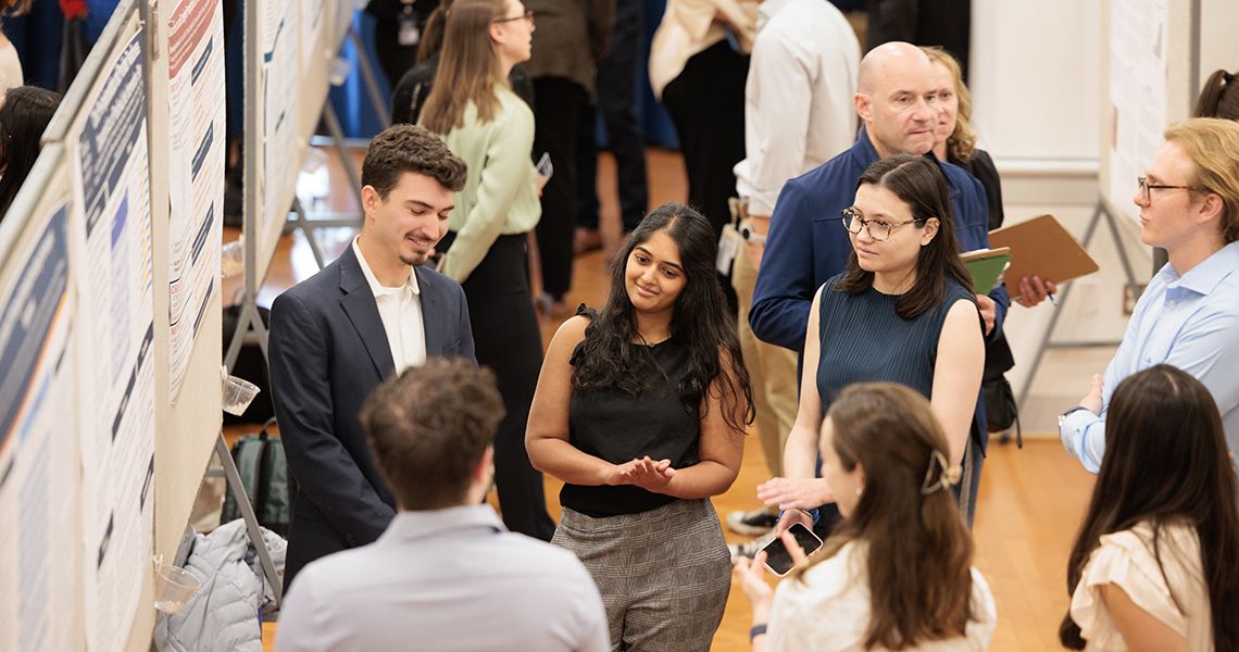 Students explain their research during poster session