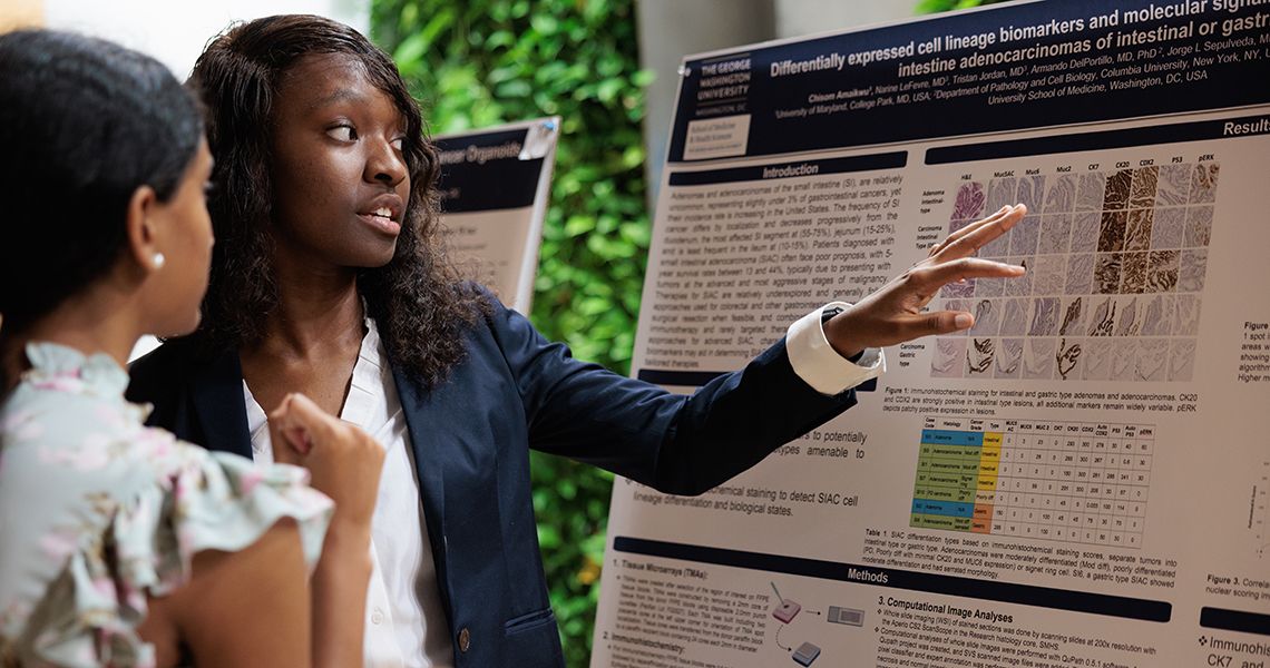 SPARC student discusses research poster