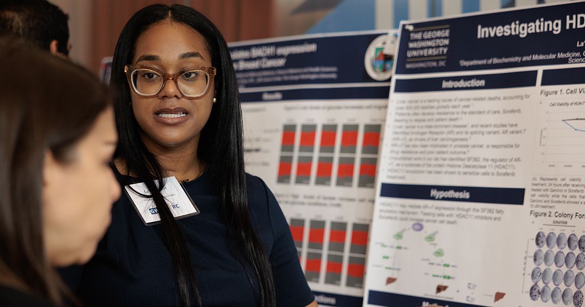 SPARC student discusses research poster