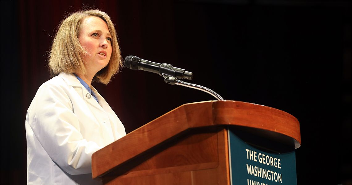 Christina Prather speaks at podium