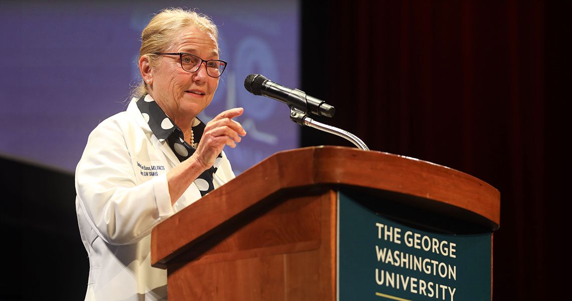 Dean Bass speaks at podium