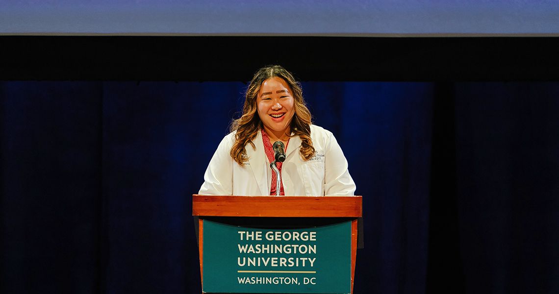 Amy Yi, MD class of 2025, speaks at podium
