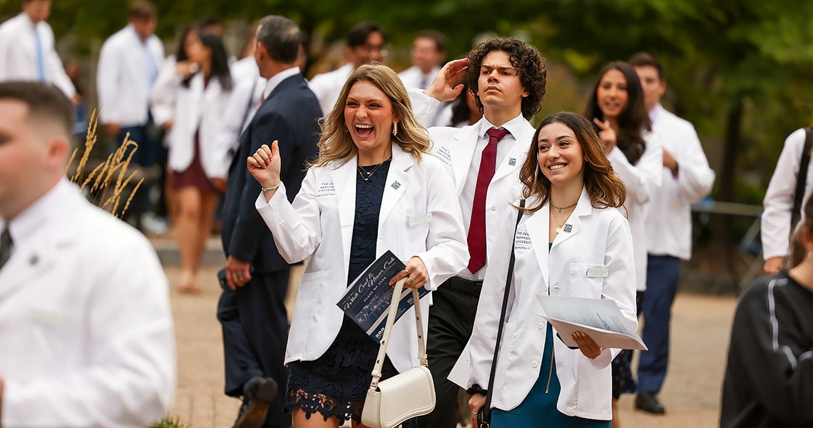 Happy MD students leaving white coat ceremony