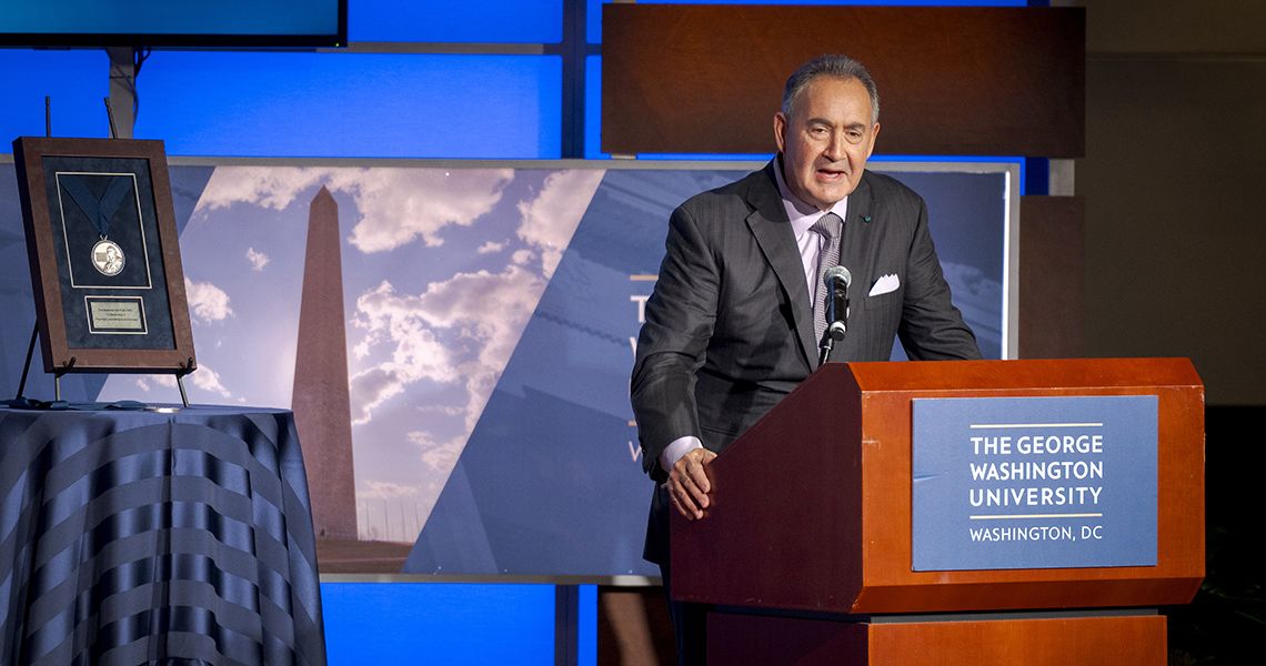 Jonathan Perlin speaks at podium