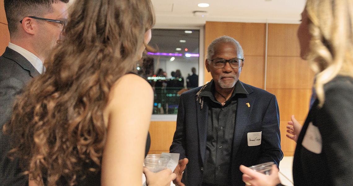 Howard Straker, PhD ’18, MPH, PA-C, chats with colleagues
