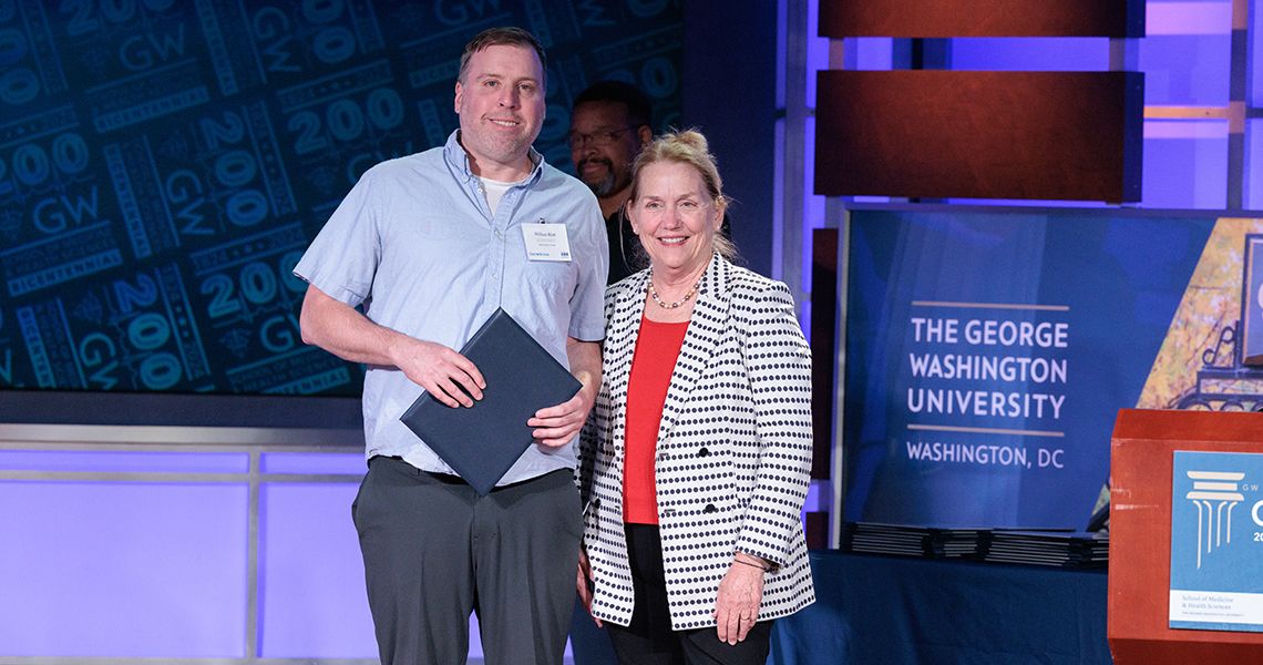 Staff Excellence awardee with Dean Bass
