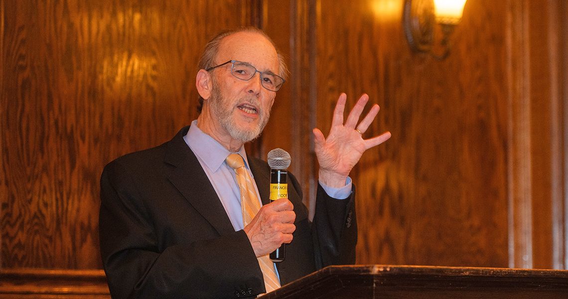 Lawrence “Bopper” Dayton, MD ’85, MSPH, speaking at podium