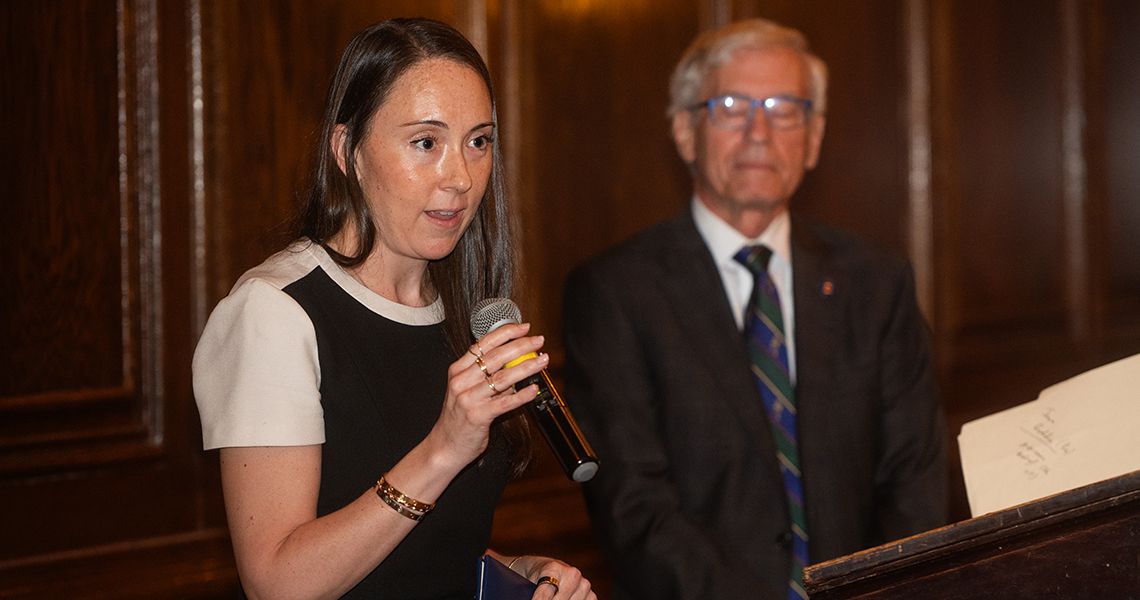 Megan Quintana, MD, speaks at podium 