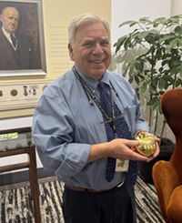 Dr. Scwartz holds his Golden Apple Award