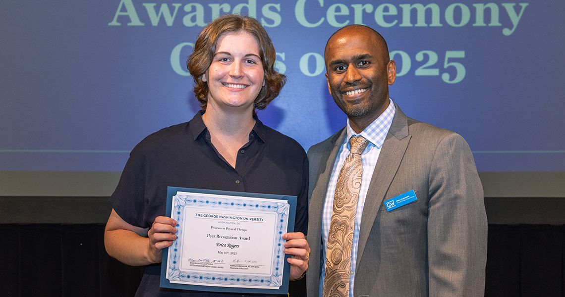 Honoree with citation posing with faculty member