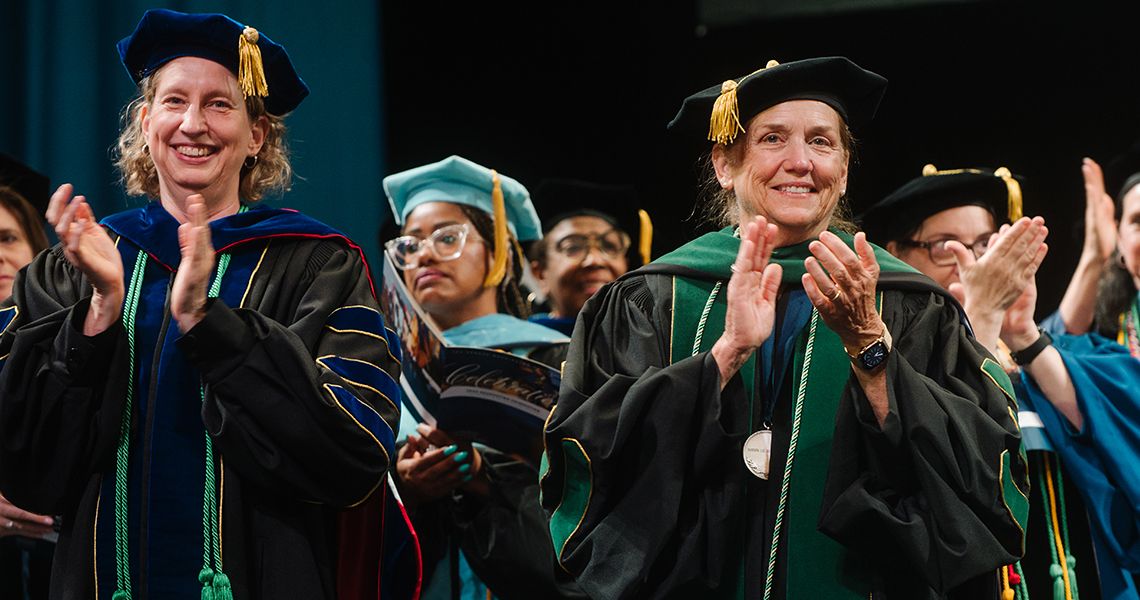 Left, Tamara Ritsema, PhD, MPH, and Dean Barbara Bass, MD applause the Health Sciences graduates 