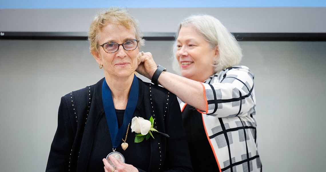President Granberg puts medal on Dr. Puchalski
