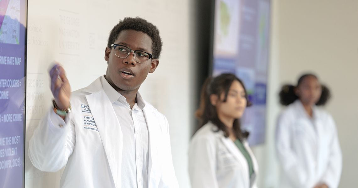 DC High School student speaks at end of program research poster session