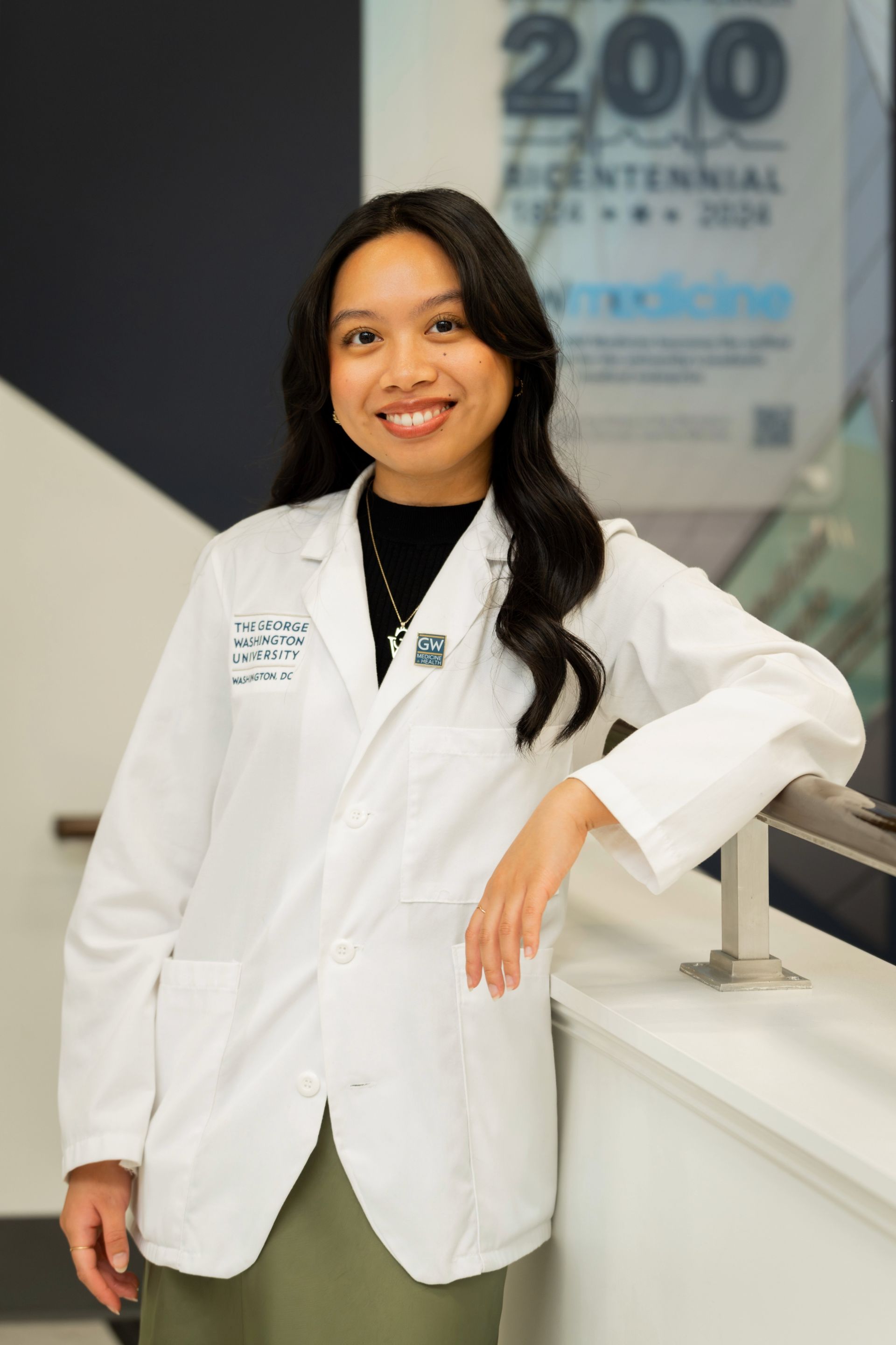 Image of woman with long dark hair wearing a white doctor's coat